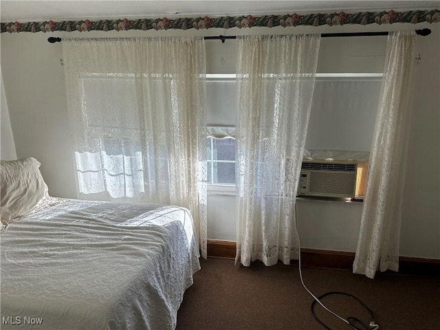 bedroom with dark colored carpet and cooling unit