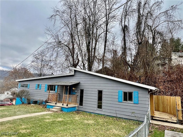 back of property with a lawn and central AC unit