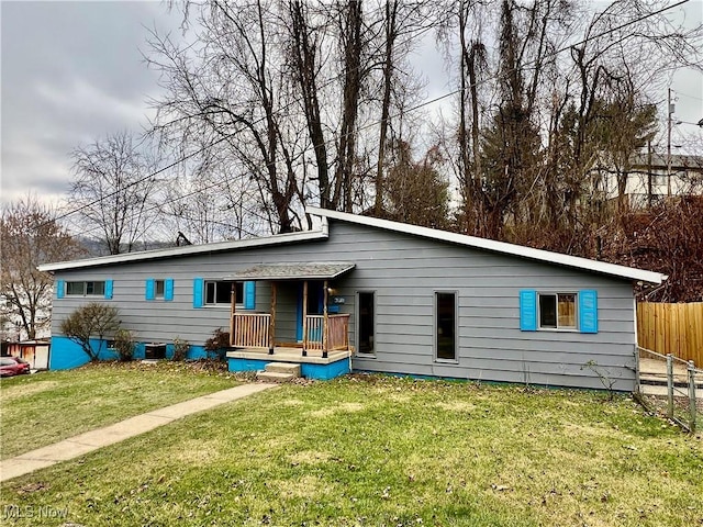 rear view of property featuring central AC and a yard