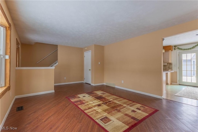 unfurnished room featuring hardwood / wood-style floors and a textured ceiling