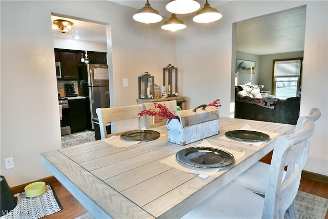 dining space with light hardwood / wood-style floors