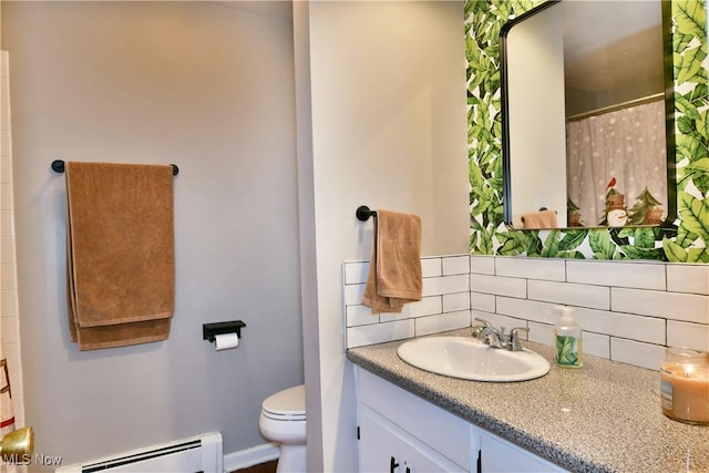 bathroom with tasteful backsplash, toilet, vanity, and baseboard heating