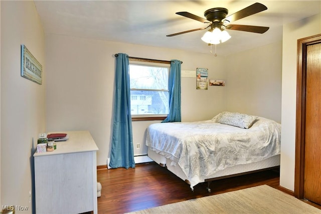 bedroom with ceiling fan and dark hardwood / wood-style floors