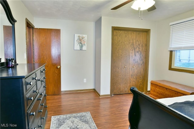 bedroom with ceiling fan, light hardwood / wood-style floors, and a closet