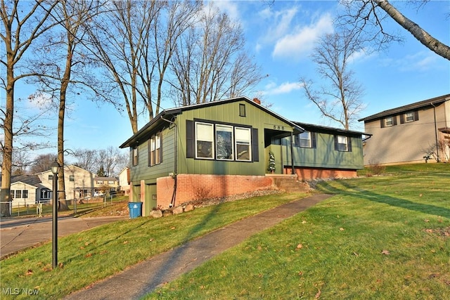 view of front of home with a front yard and a garage