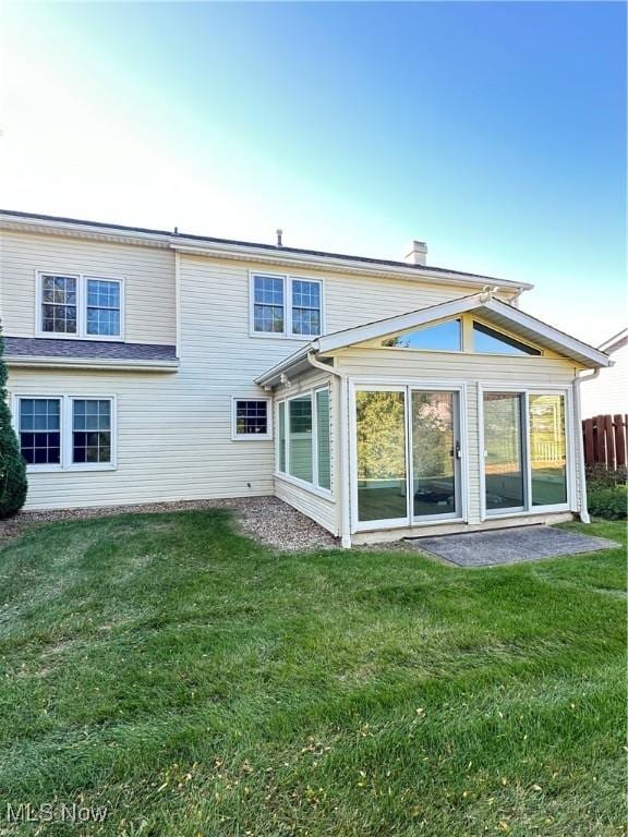 rear view of house with a lawn