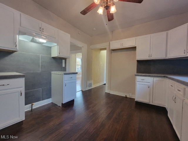 kitchen featuring white cabinets, dark hardwood / wood-style floors, ceiling fan, and tile walls