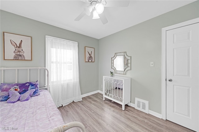 bedroom with ceiling fan and light hardwood / wood-style floors