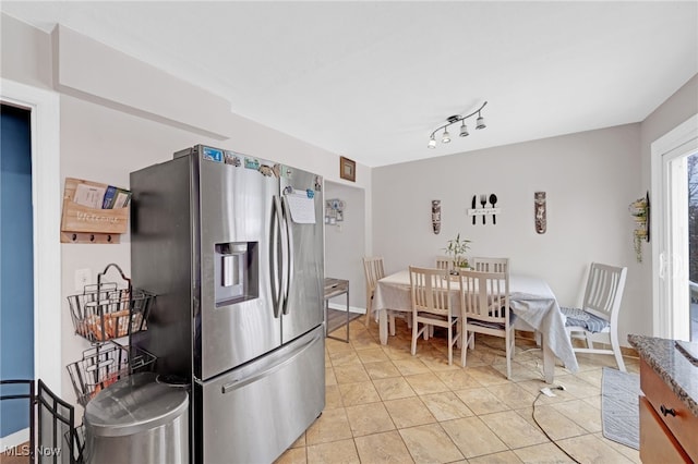 kitchen featuring light tile patterned floors and stainless steel refrigerator with ice dispenser