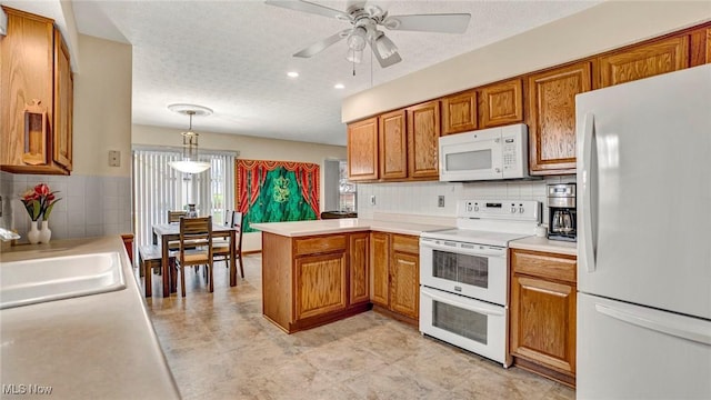 kitchen with ceiling fan, tasteful backsplash, kitchen peninsula, decorative light fixtures, and white appliances