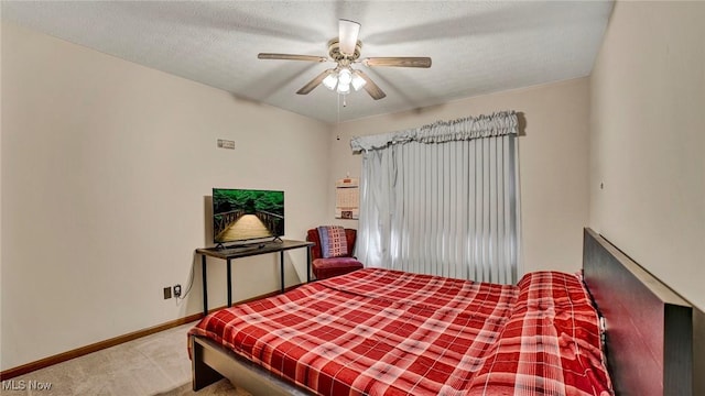 carpeted bedroom with a textured ceiling and ceiling fan