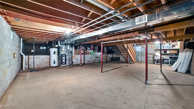 basement featuring heating unit and electric water heater