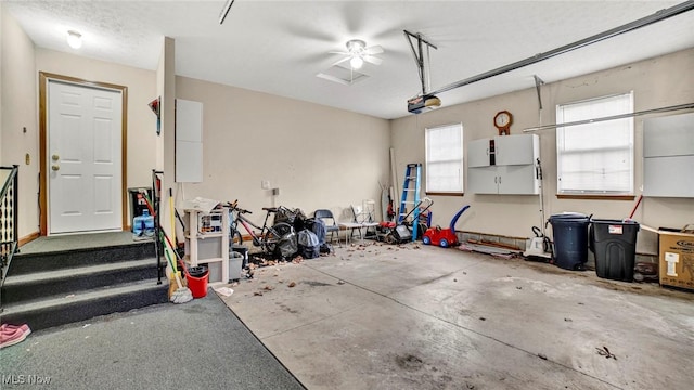 garage with ceiling fan and a garage door opener