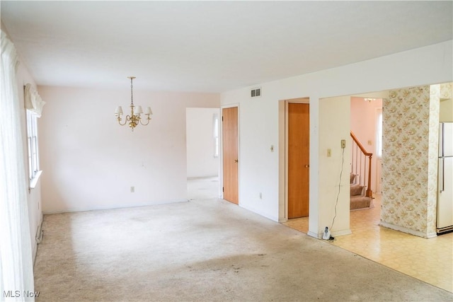 spare room with a chandelier