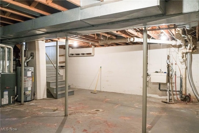 basement featuring sink and gas water heater