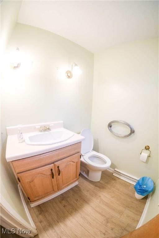 bathroom with vanity, hardwood / wood-style flooring, and toilet