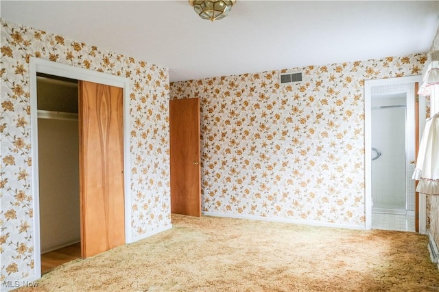 unfurnished bedroom with carpet flooring and a closet