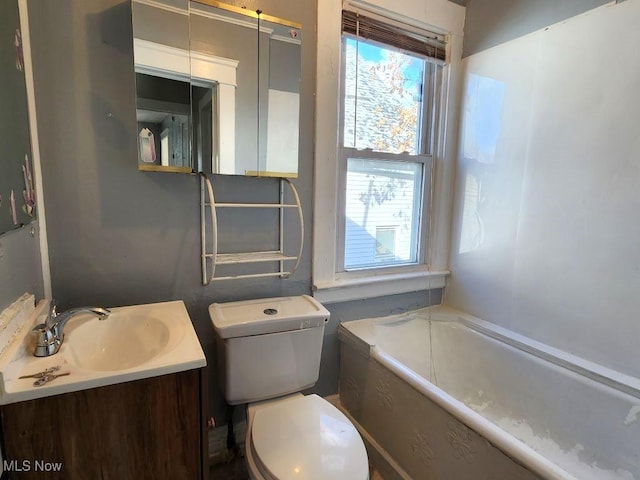 bathroom with vanity, toilet, and a bathtub