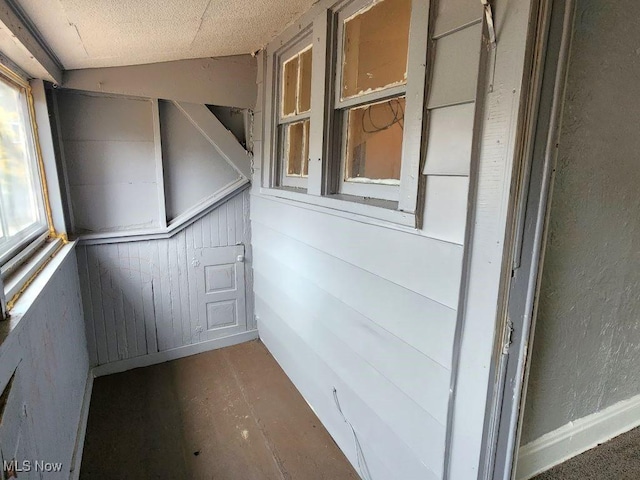 unfurnished sunroom featuring lofted ceiling