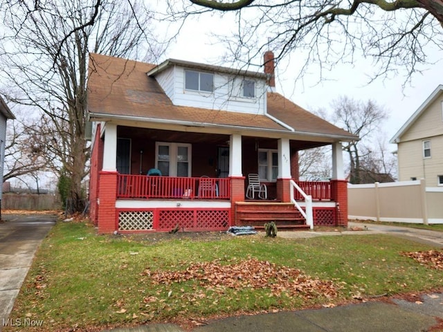 view of front facade with a porch and a front lawn