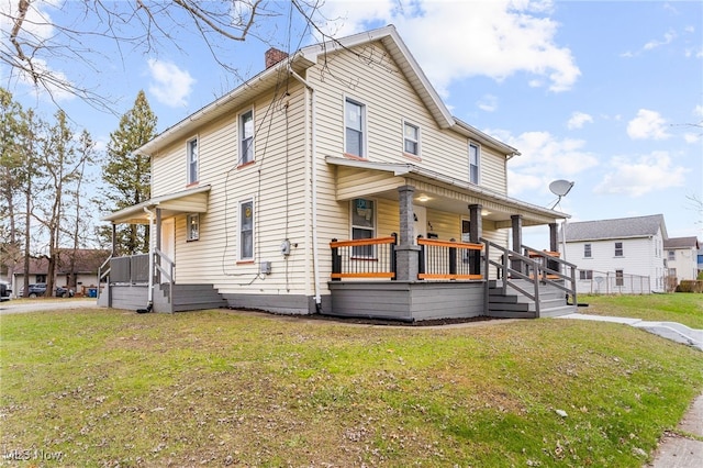 view of front facade with covered porch and a front yard