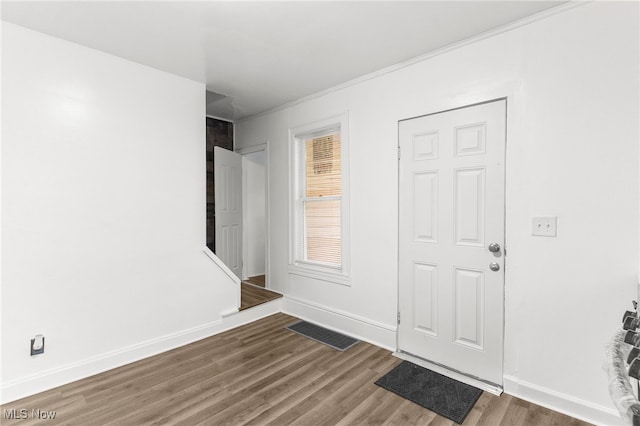 entryway with crown molding and hardwood / wood-style flooring