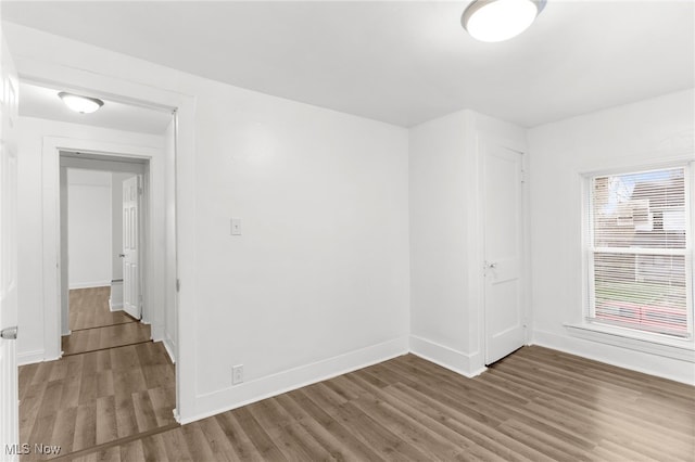 empty room featuring dark wood-type flooring