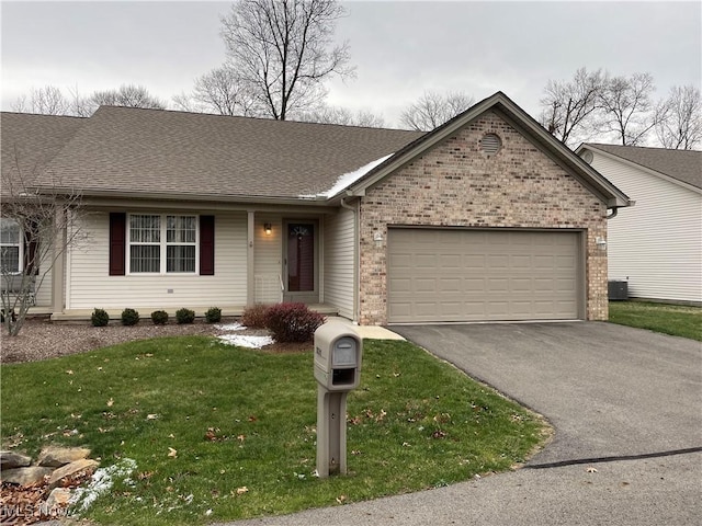 single story home featuring a front yard, central AC, and a garage