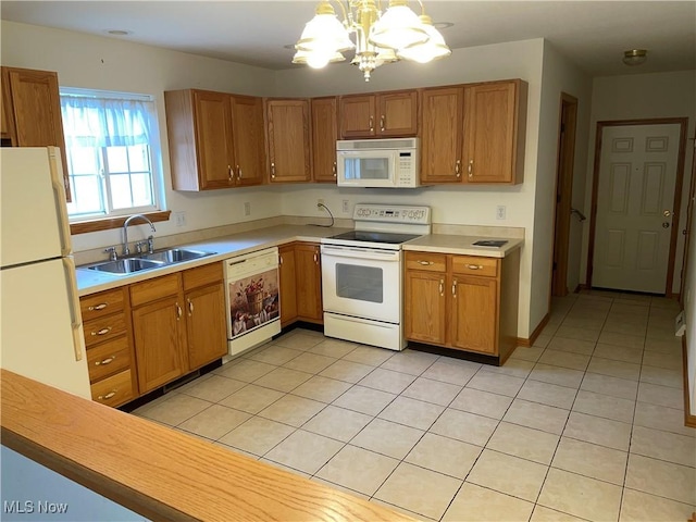 kitchen with pendant lighting, white appliances, sink, light tile patterned floors, and a chandelier