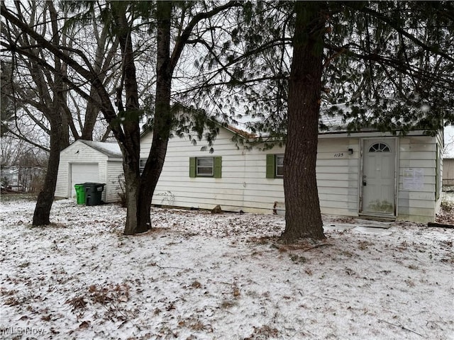 exterior space featuring an outbuilding and a garage