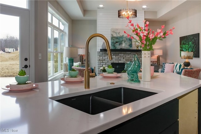 kitchen with a chandelier, decorative light fixtures, a healthy amount of sunlight, and sink