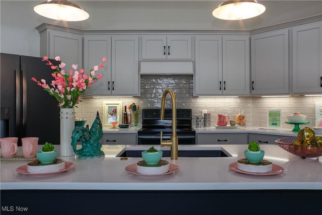 kitchen with tasteful backsplash, electric range, sink, and stainless steel fridge with ice dispenser