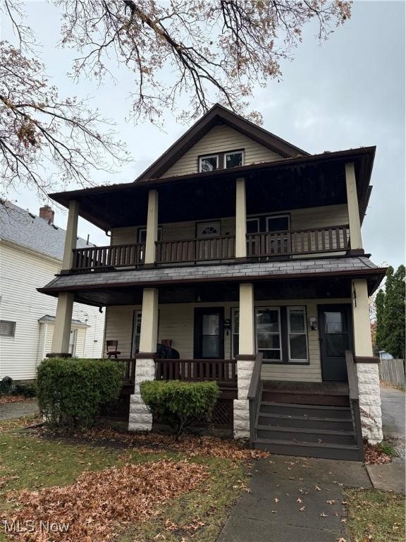 view of front of property featuring covered porch and a balcony