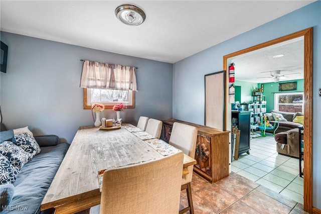 tiled dining area featuring ceiling fan and a wealth of natural light