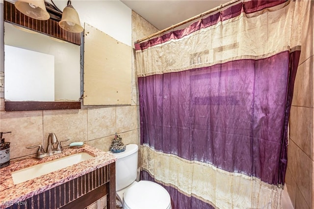 bathroom with vanity, a shower with shower curtain, tile walls, and toilet