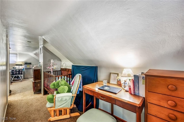 carpeted office space with a textured ceiling and vaulted ceiling