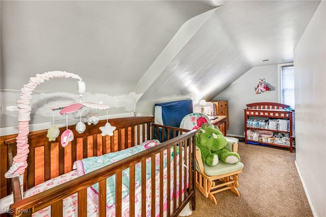 carpeted bedroom with a crib and vaulted ceiling