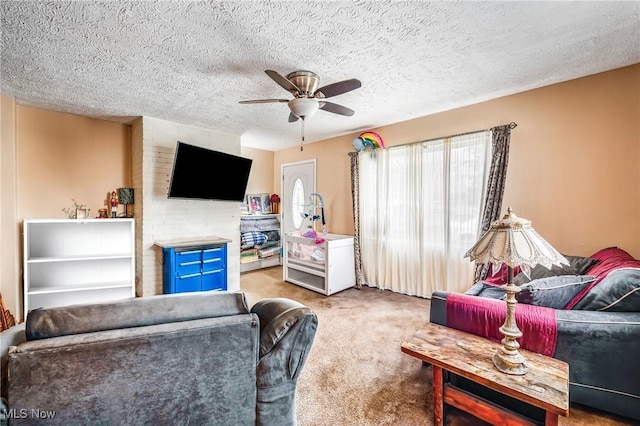 living room featuring carpet flooring, a textured ceiling, and ceiling fan