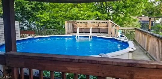 view of pool featuring a wooden deck