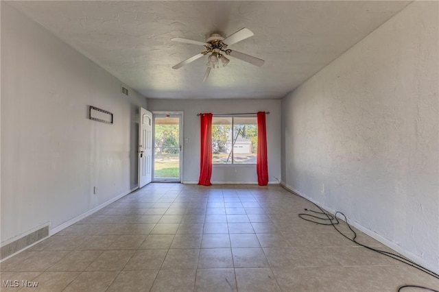 spare room featuring ceiling fan and light tile patterned floors