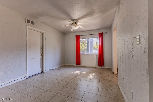 tiled empty room with ceiling fan