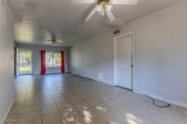 tiled spare room with ceiling fan