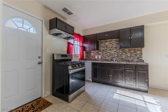 kitchen featuring light tile patterned floors, sink, tasteful backsplash, and stainless steel range with gas stovetop