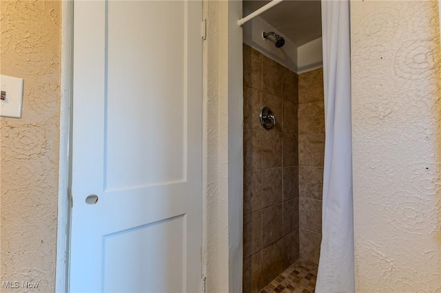 bathroom featuring a shower with curtain