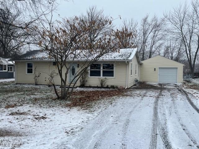 single story home with a garage and an outbuilding