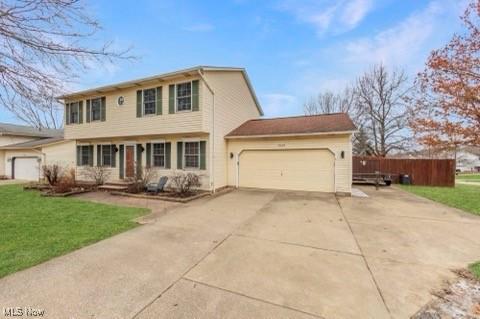 view of front of home with a garage and a front lawn