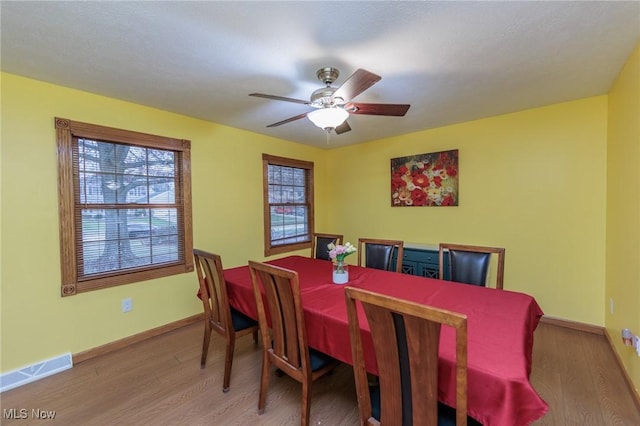 dining area featuring ceiling fan and wood-type flooring