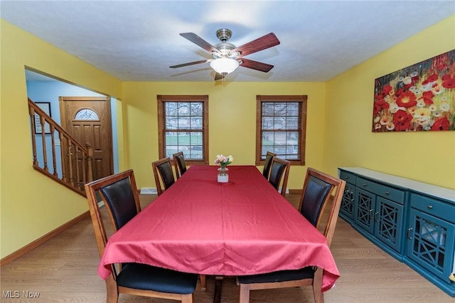 dining space featuring ceiling fan and light wood-type flooring