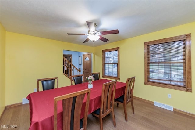 dining area with ceiling fan and light hardwood / wood-style flooring