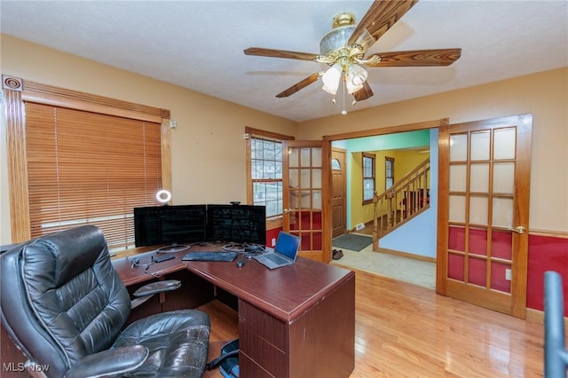 office space featuring hardwood / wood-style flooring, ceiling fan, and french doors